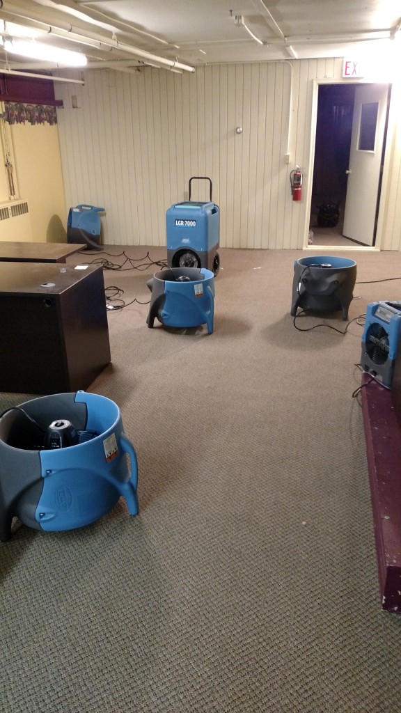 Commercial dehumidifiers and air movers used to dry this office that was flooded with 800 gallons of water in a water mitigation project completed by Tri-County Restoration & Cleaning.